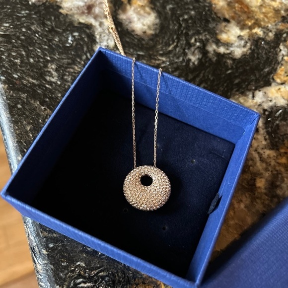 Swarovski gold tone pendant necklace with pave crystals. Cones in box.